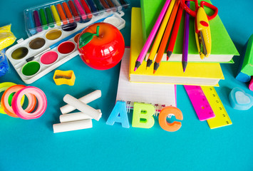 Stationery for study at school lies on blue. Back to school. Rainbow color