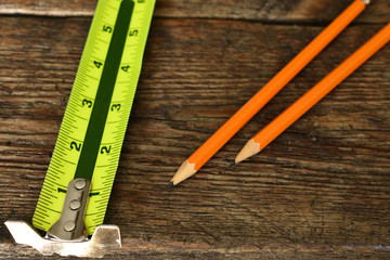 Yellow Measuring Tape and Two Pencils 