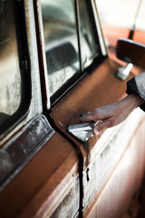 Woman hands opening An old Car