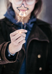.Teenage Girl Holds A Sparkler In Her Hands.