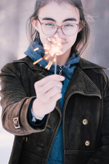 .Teenage Girl Holds A Sparkler In Her Hands.