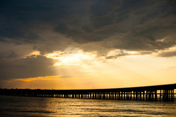 Destin Florida Sunset over a Bridge Pier wth Rays of Light