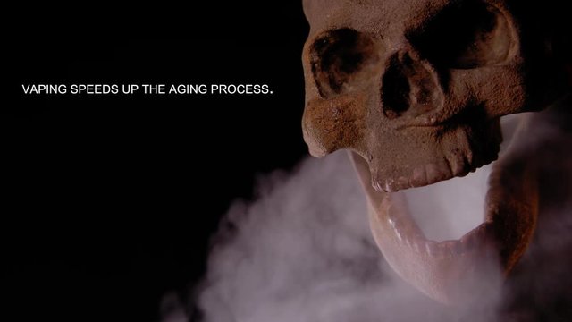 VAPING SPEEDS UP THE AGING PROCESS.  HUMAN SKULL VAPES AS A MESSAGE APPEARS IN NEGATIVE SPACE.  SHOT IN 4K, 10 BIT, ALL-INTRA.