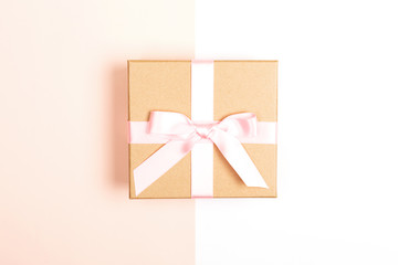 Gift box on pink and white background