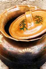  ceramic clay pot of brown color uncovered, takes close-up