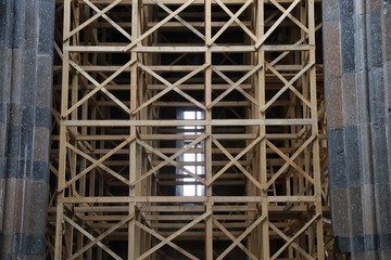 Fototapeta premium Restoration of old wooden churche against the gray sky. Kars