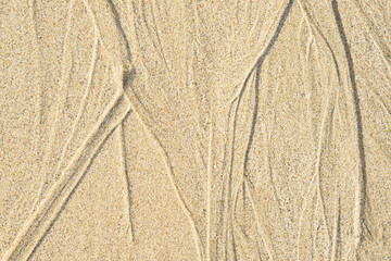 Interesting pattern in sand made by water for background