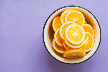 Orange slices in a bowl, top view