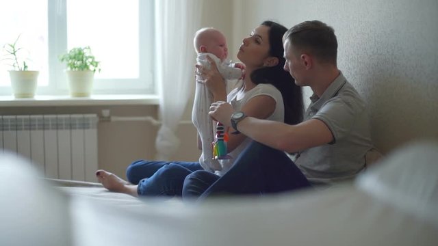 Mother and Father Soothing Baby Together