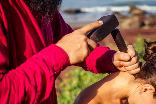 male master makes Thai massage Tok-sen spa therapy physiology by the sea ocean beach.Beautiful woman having a relaxing thai back massage with set for massage toksen,Body care relaxation resort