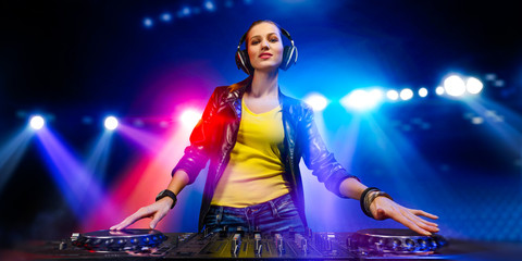 Fototapeta na wymiar Female dj in nightclub. Mixed media