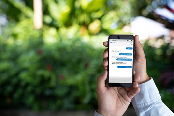 man touch on button instant messaging app on mobile phone