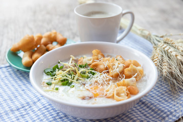 Breakfase meal. Congee or Rice porridge minced pork, boiled egg with soy milk and Chinese deep fried double dough stick