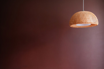 Thai woven bamboo pendant lamp with Merlot red wall background