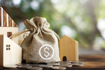 Little wood house model with coins saving for residential .