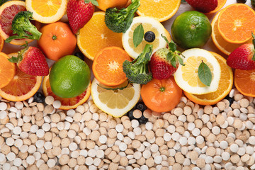 Fototapeta na wymiar Vitamins in fruits and vegetables and vitamin pills