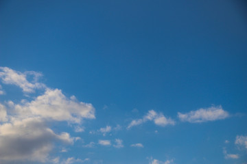 white fluffy clouds on  bright blue sky in Sunny weather