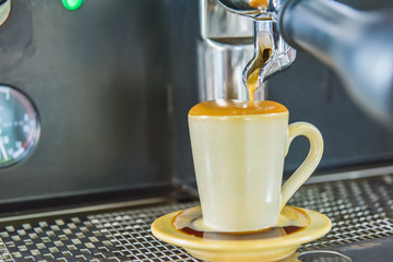 Espresso cup on the background of coffee machines, black coffee morning on coffee maker
