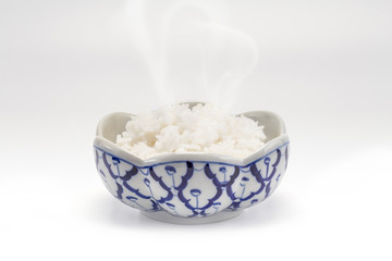 A Thai rice steam in a traditional blue porcelain bowl