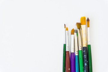 a variety of brushes for painting on a neutral white background