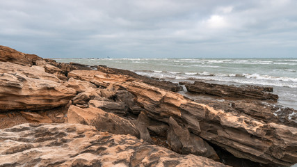 Fototapeta na wymiar Rocky sea coast in cloudy weather