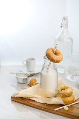 Sugar glazed donuts and bottle of milk.