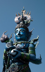 Fototapeta premium Chiang Rai Thailand, giant guardian at Wat Rong Seur Ten or the Blue temple