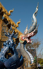 Fototapeta na wymiar Chiang Rai Thailand, guardian dragon at entrance to Wat Rong Seur Ten or the Blue temple
