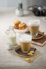 Coffee break time table top shot. Coffee with milk served with desserts.