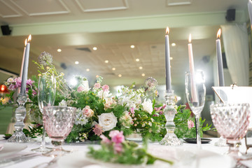 Floral decoration for wedding ceremony romance dining. Wedding banquet , festive decor. Bouquet from spring and summer flowers. Table layout. Restaurant interior. Concept of service and catering.