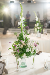Floral decoration for wedding ceremony romance dining. Wedding banquet , festive decor. Bouquet from spring and summer flowers. Table layout. Restaurant interior. Concept of service and catering.