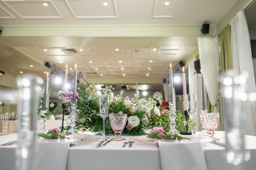 Floral decoration for wedding ceremony romance dining. Wedding banquet , festive decor. Bouquet from spring and summer flowers. Table layout. Restaurant interior. Concept of service and catering.