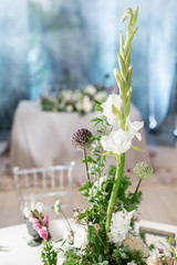 Floral decoration for wedding ceremony romance dining. Wedding banquet , festive decor. Bouquet from spring and summer flowers. Table layout. Restaurant interior. Concept of service and catering.