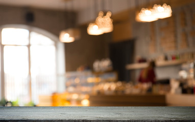 image of wooden table in front of abstract blurred background of resturant lights