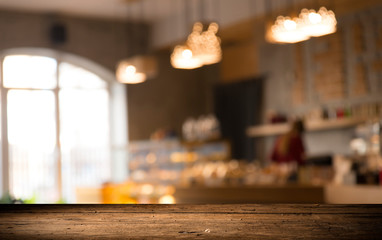 image of wooden table in front of abstract blurred background of resturant lights
