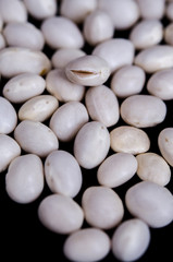 Fototapeta na wymiar White beans on black background