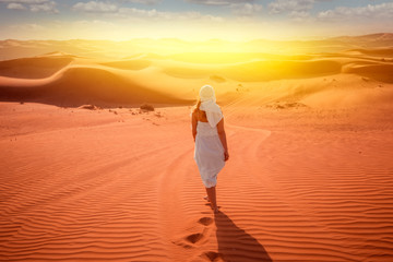 woman in beduin dress in desert