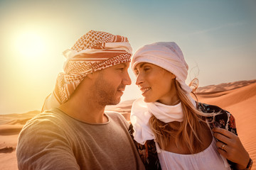 travel couple in arabian desert 