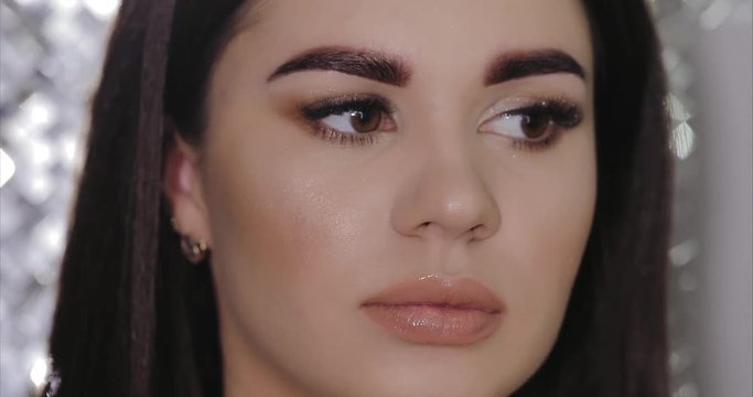 Young girl tweezing her eyebrows in a beauty salon. Eyebrow Correction. Beauty Concept. Permanent Makeup. Microblading brow.