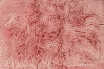 Pink fur background. Pink sheepskin background and texture.