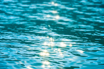 Blur tropical summer sea with bokeh sunlight wave abstract background.