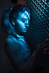 Beautiful girl, with a sporty figure, with the shadow of the screen on his face, thoughtfully...