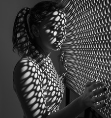 Beautiful girl, with a sporty figure, with the shadow of the screen on his face, thoughtfully...