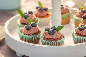 Sweet and brown cupcake with fresh blueberries and cream