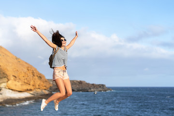 Obraz premium Pretty tourist brunette girl having fun outdoor near sea.
