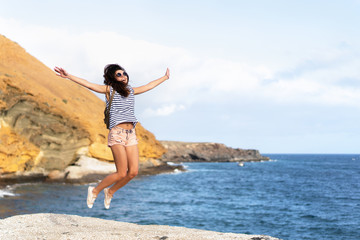 Pretty tourist brunette girl having fun outdoor near sea.