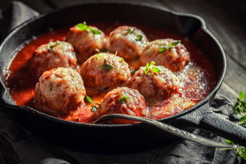 Tasty meatballs with tomato sauce and cheese