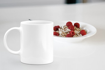 White mug next to a bowl of cereal. Perfect for businesses selling mugs, just overlay your quote or design on to the image.
