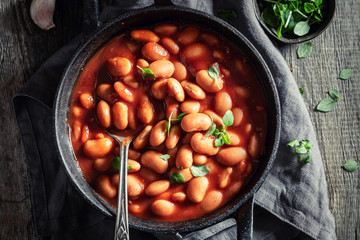 Tasty baked beans with garlic and fresh tomatoes