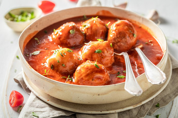 Delicious meatballs with fresh herbs and tomatoes